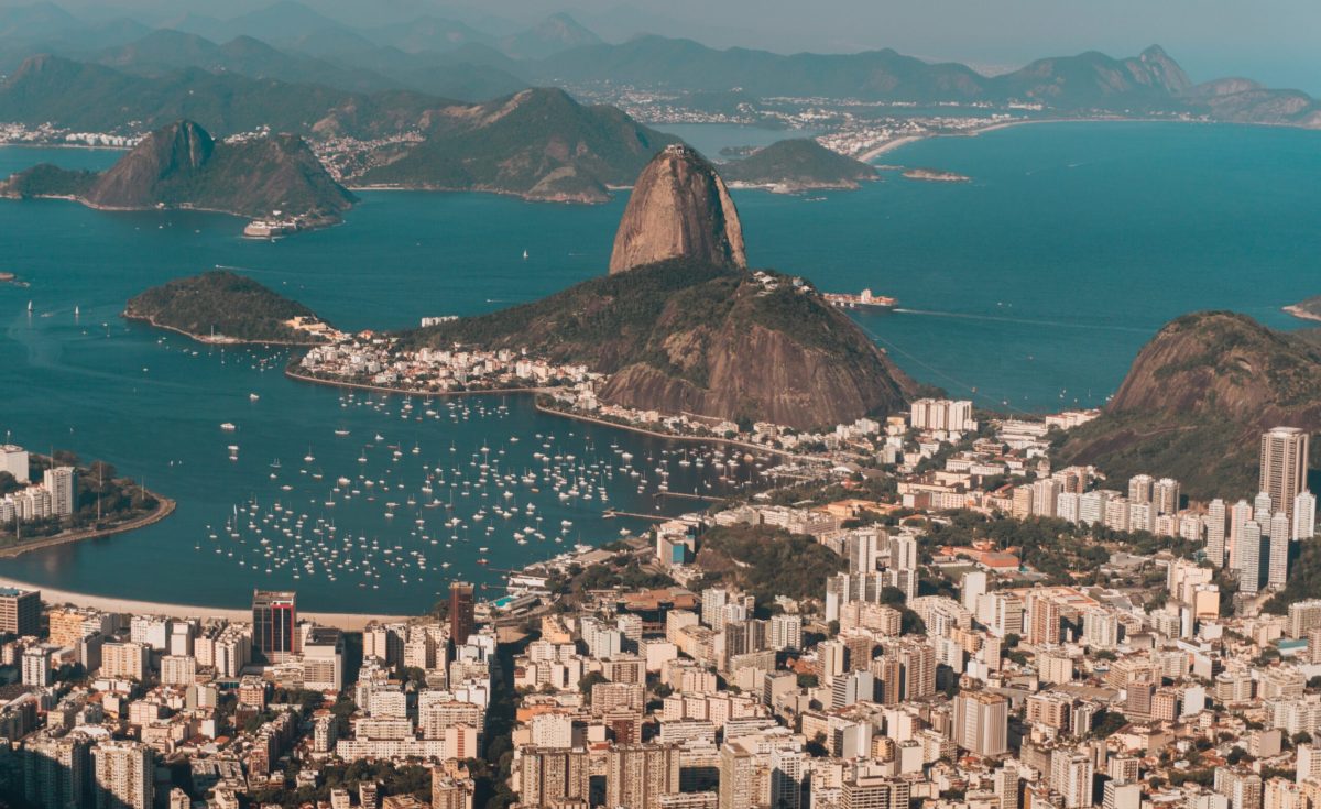 An aerial photo of Rio de Janeiro surrounded by the sea and hills under the sunlight in Brazil